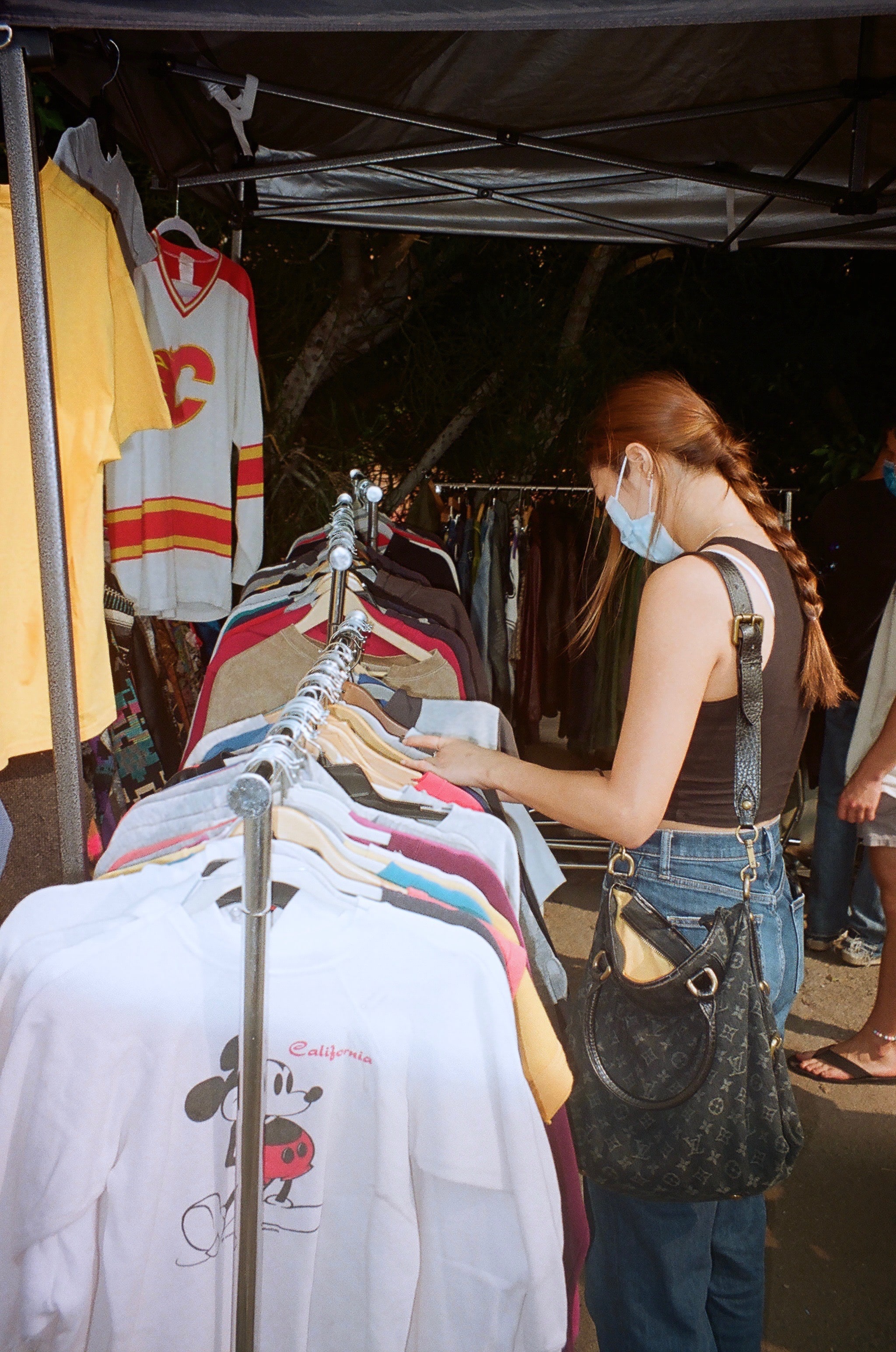 Person looking at clothes at flea market